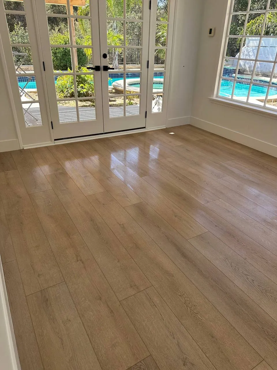 Room with French doors to the pool after cleaning
